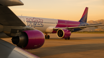 Airbus A321neo aerolinky Wizz Air na plose letiska Palermo za zlatej hodiny, pohlad spoza kridla a motora, v pozadi sicilske kopce